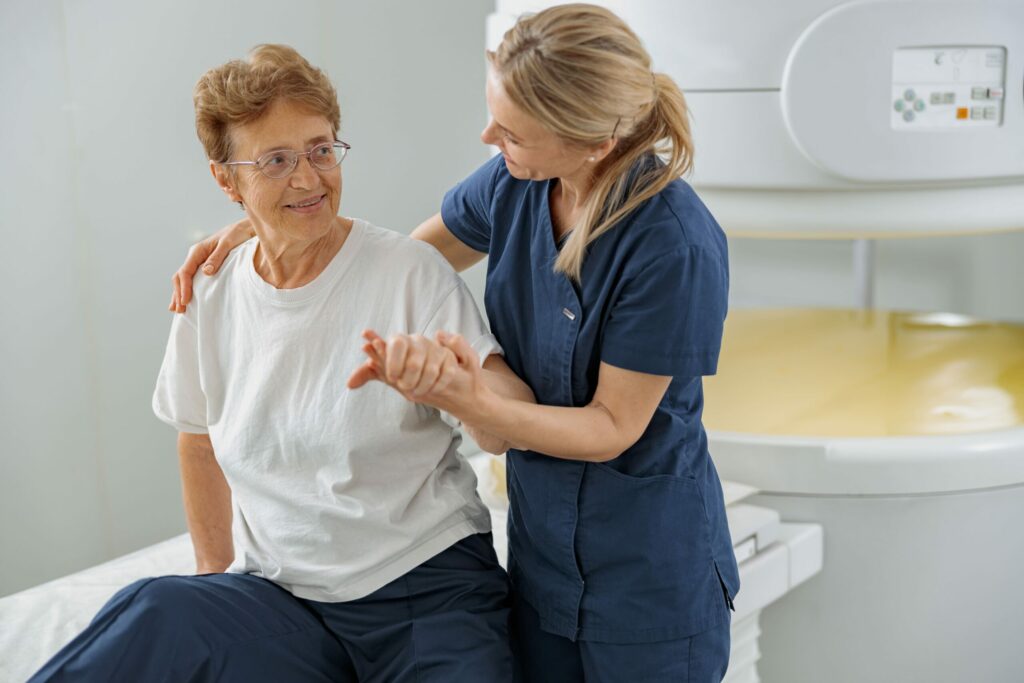 Home 8 doctor radiologist help to patient sit after proce 2023 11 27 04 55 24 utc 2 scaled 1