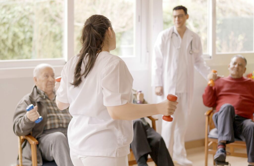 Home 10 physiotherapist explaining the exercises to a grou 2024 05 06 18 57 02 utc 2 min scaled 1